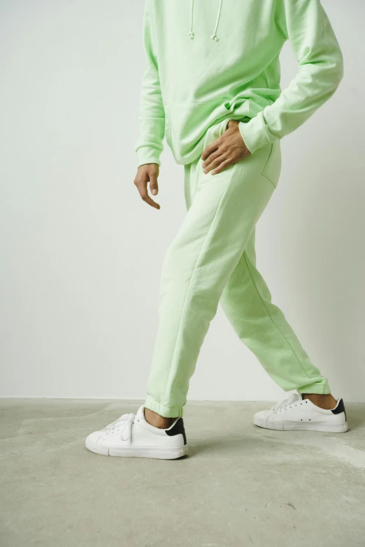 a man in a green sweatshirt and pants, happening, pastell colours, close-up on legs, けもの, product view