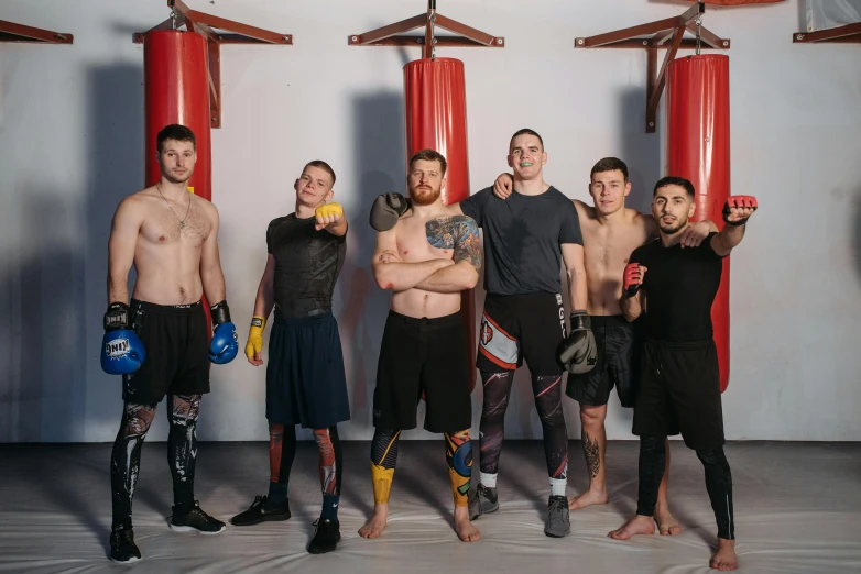 a group of men standing next to each other, by Ilya Ostroukhov, pexels contest winner, kickboxing, transformation, background image, ukraine. professional photo