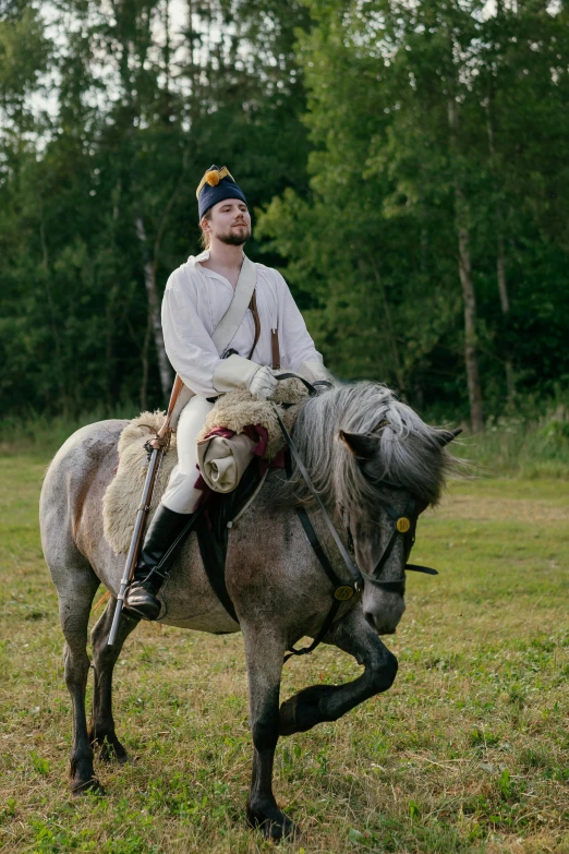 a man riding on the back of a horse in a field, inspired by Horace Vernet, unsplash, renaissance, russian costume, grey, square, high quality photo