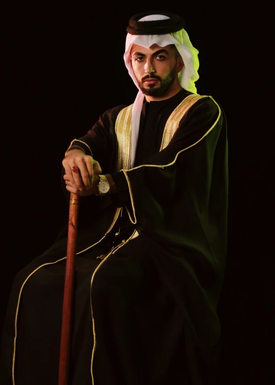 a man sitting on a chair with a cane, an album cover, inspired by Sheikh Hamdullah, pexels contest winner, dau-al-set, traditional costume, ((portrait)), nigth, confident looking