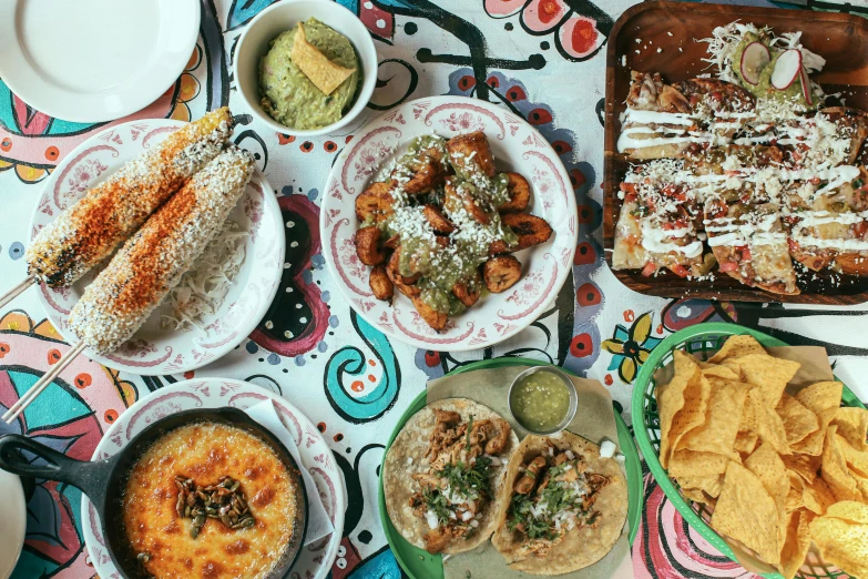 a number of plates of food on a table, by Carey Morris, mexican, 🦩🪐🐞👩🏻🦳, promo image, background image