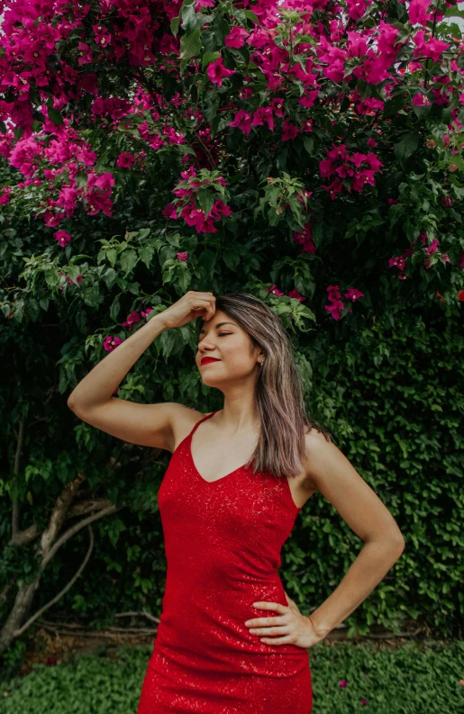 a woman in a red dress posing for a picture, by Robbie Trevino, pexels contest winner, with soft bushes, julia fuentes, gif, sleeveless