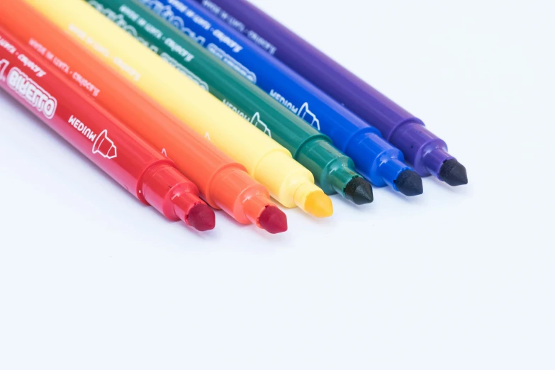 a group of colored markers sitting next to each other, by Nicolette Macnamara, detailed product image, purple and scarlet colours, 6 colors, emerald