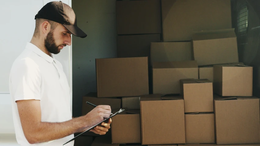 a man standing in front of a truck holding a clipboard, pexels contest winner, furniture, inspect in inventory image, melbourne, thumbnail