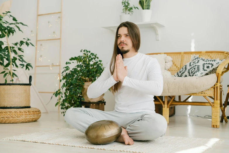 a man is sitting on the floor and meditating, pexels contest winner, renaissance, in a white boho style studio, avatar for website, sitting across the room, squatting