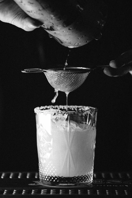 a person pouring a drink into a glass, a black and white photo, renaissance, promo image, ffffound, milkshake, recipe