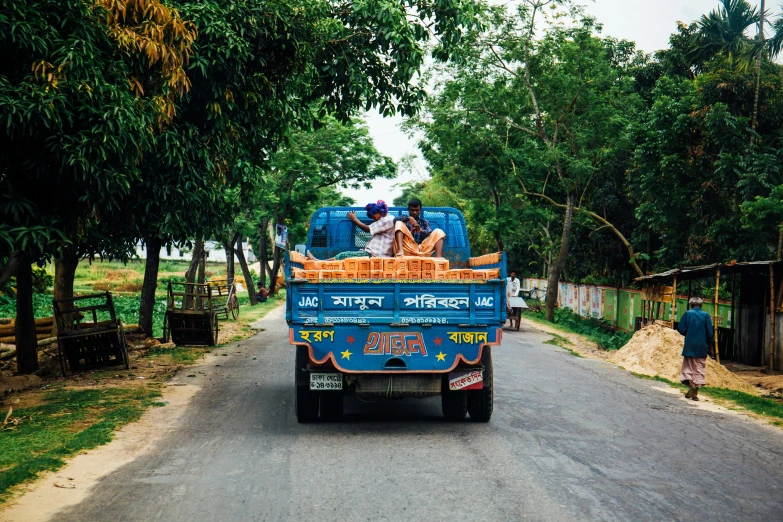 people are riding in the back of a truck, pexels contest winner, bengal school of art, on the side of the road, 🦑 design, slide show, high resolution photograph