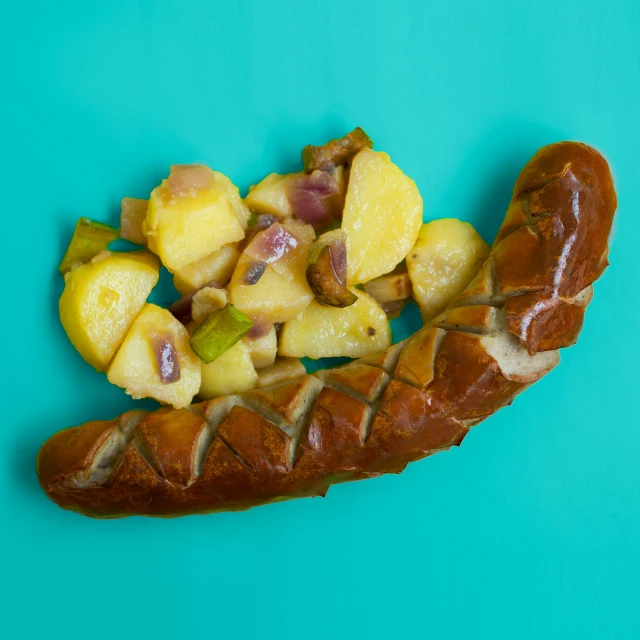 a hot dog sitting on top of a blue surface, a portrait, by Matthias Stom, shutterstock contest winner, dau-al-set, fruit, polish food, potato, salad