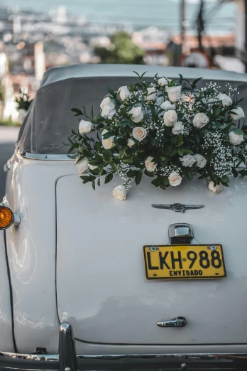 a white car parked on the side of the road, floral headpiece, in sao paulo, marriage, tag