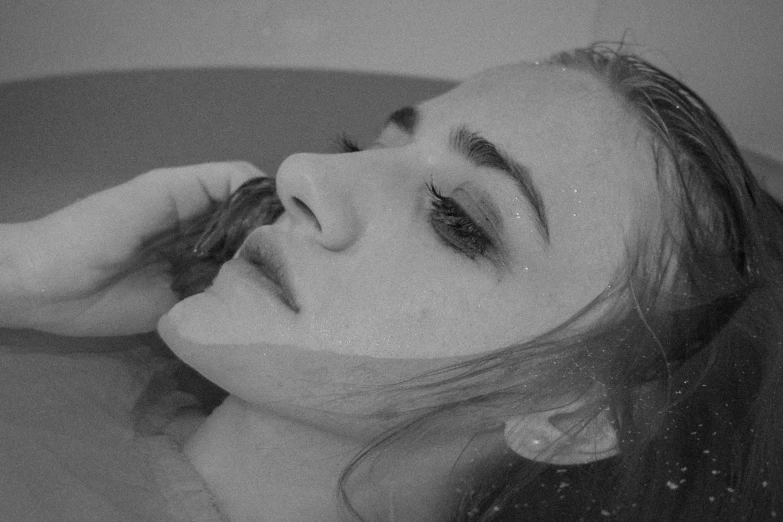 a black and white photo of a woman in a bathtub, a black and white photo, tumblr, exhausted face close up, illustration », gif, 4k greyscale hd photography