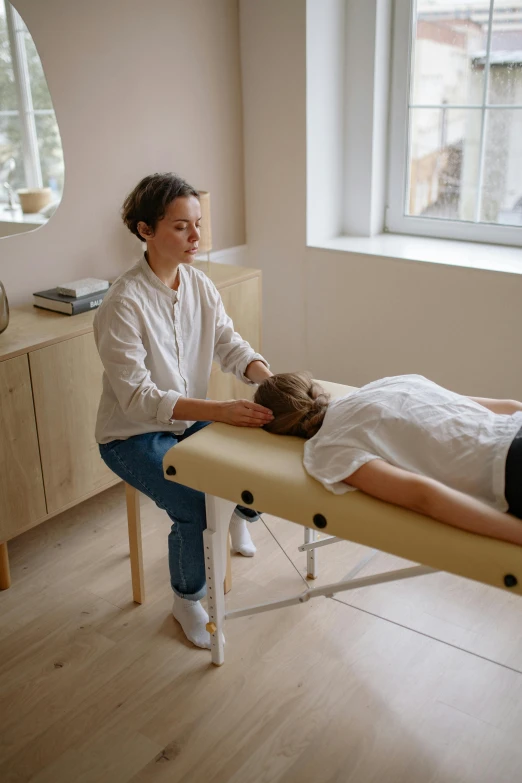 a woman getting a massage in a room, on a table, sanja stikovic, your head turns back, high-quality photo