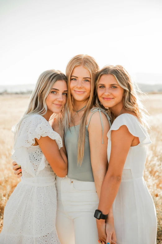 three women standing next to each other in a field, a picture, by Chase Stone, unsplash, clean blonde hair, wearing a cute white dress, siblings, various posed