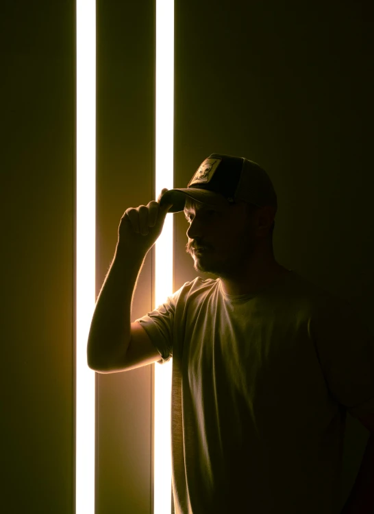 a man that is standing in front of a wall, by Eglon van der Neer, light and space, studio ambient lighting, reflection of phone in visor, profile image, instagram photo