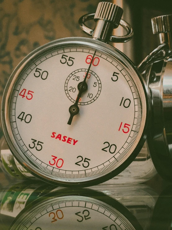 a close up of a stopwatch on a table, by Jessie Algie, pexels contest winner, process art, savory, paul davey, vintage race footage, thumbnail