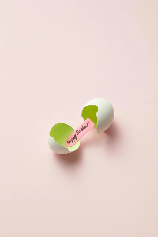 a broken egg sitting on top of a pink surface, symmetrical sticker design, lime green, holding easter eggs, product shoot