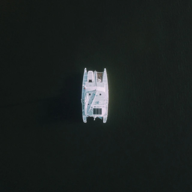 a white boat floating on top of a body of water, by Attila Meszlenyi, satelite imagery, high quality picture, dark ( spaceship ), shot on hasselblad