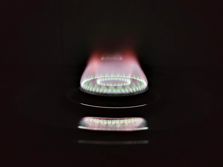 a gas stove with a flame coming out of it, a hologram, by Ian Fairweather, pexels contest winner, bauhaus, shot on sony alpha dslr-a300, red reflective lens, low detail, long exposure