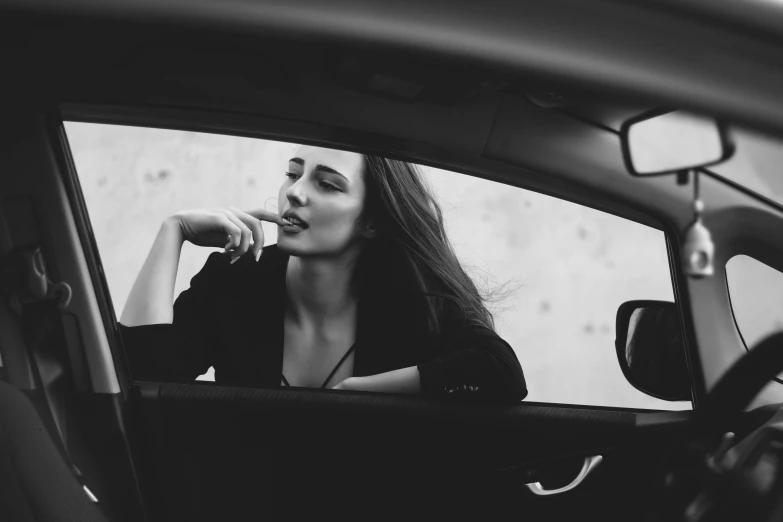 a woman sitting in a car brushing her teeth, a black and white photo, by Emma Andijewska, pexels contest winner, handsome girl, minimalistic art, deviantart artstation cgscosiety, black car