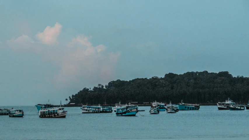 a group of boats floating on top of a body of water, by Joseph Severn, pexels contest winner, hurufiyya, humid evening, shades of blue and grey, assamese aesthetic, banner