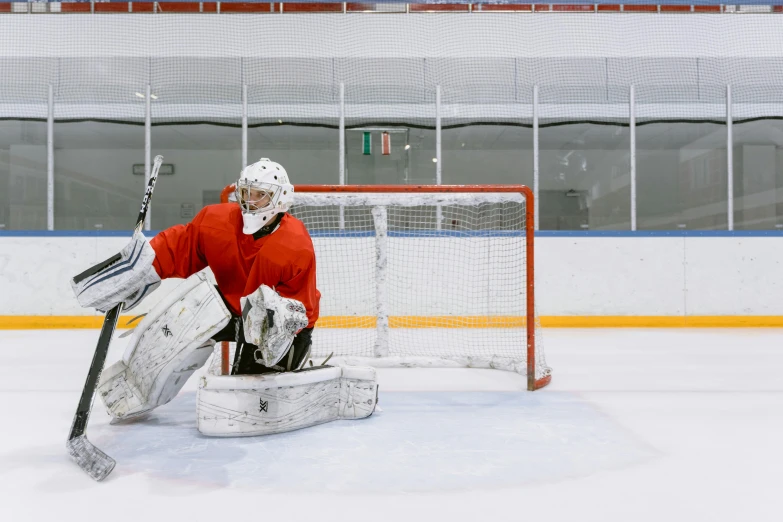a hockey goalie sitting on the ice in front of a net, pexels contest winner, 15081959 21121991 01012000 4k, high quality product image”, grey, center frame medium shot