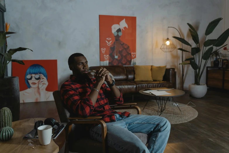 a man sitting in a chair drinking from a cup, pexels contest winner, black arts movement, living room vibe, ( ( dark skin ) ), trending on artstationhq, portrait of tall