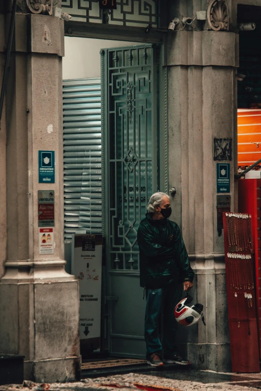 a man that is standing in front of a building, by Carlo Martini, pexels contest winner, exiting store, buenos aires, cyberpunk old man, lockers