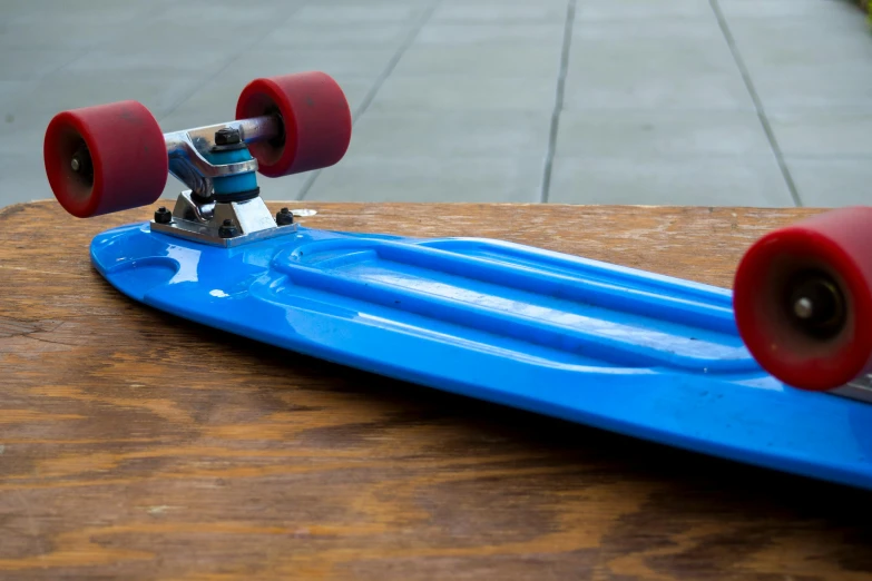 a blue skateboard sitting on top of a wooden table, irwin penn, product view, title, full res