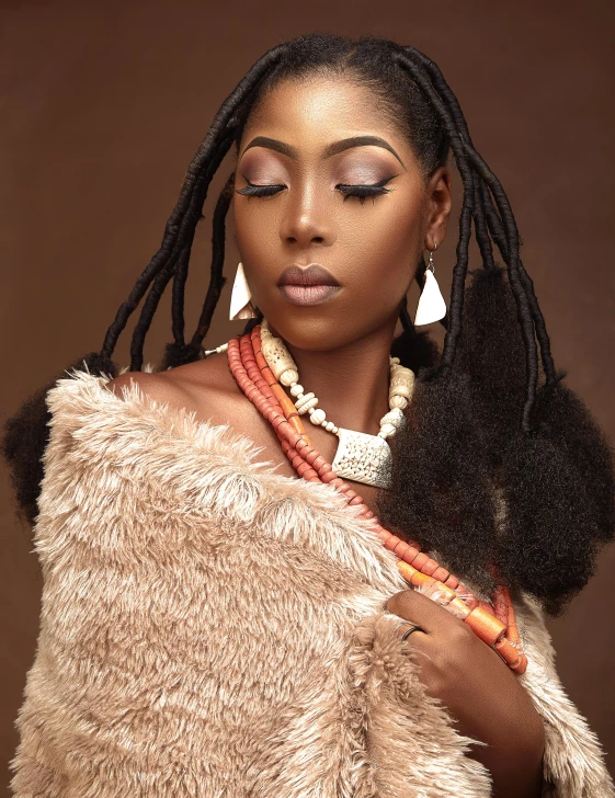 a woman in a fur coat posing for a picture, an album cover, inspired by Chinwe Chukwuogo-Roy, trending on pexels, short dreadlocks with beads, brown:-2, pastel', traditional beauty