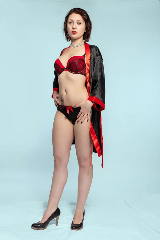 a woman in lingerie posing for a picture, an album cover, inspired by Torii Kiyonobu I, reddit, full body black and red longcoat, on a mannequin. high resolution, fashion shoot 8k, black+velvet+red+turquoise