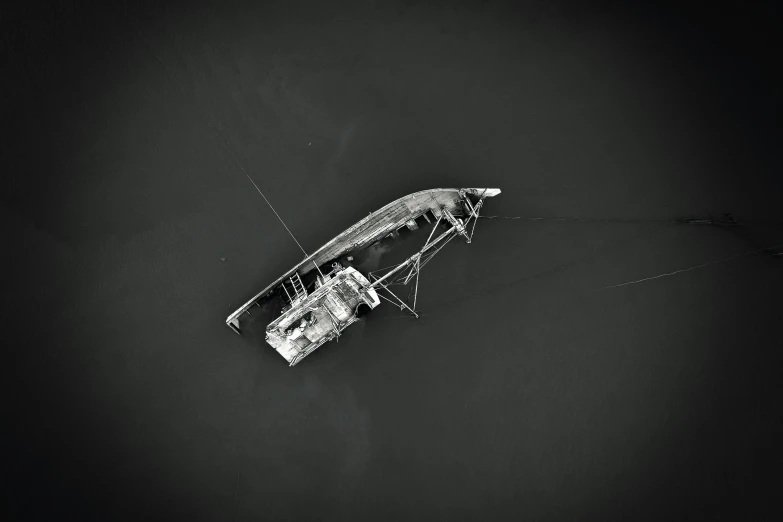 a small boat floating on top of a body of water, a black and white photo, by Patrick Pietropoli, unsplash, broken antenna, satellite view, g cgsociety, fishing boat