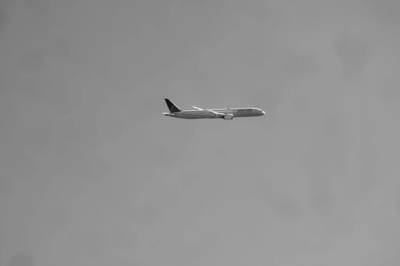 a black and white photo of an airplane in the sky, a black and white photo, minimalism, hd footage, captured on canon eos r 6, untitled, traveller