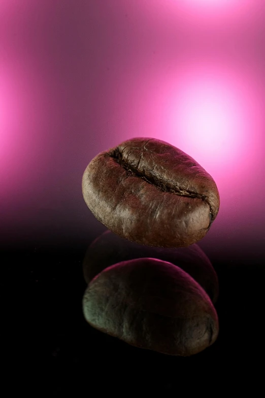 a coffee bean sitting on top of a table, an album cover, by Dave Allsop, photorealism, dramatic pink light, sperical hdri map, arabica style, brown:-2
