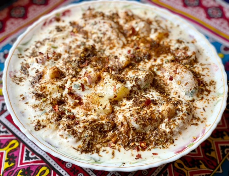 a close up of a plate of food on a table, by Abdullah Gërguri, hurufiyya, creamy, mix, epicurious, bowl