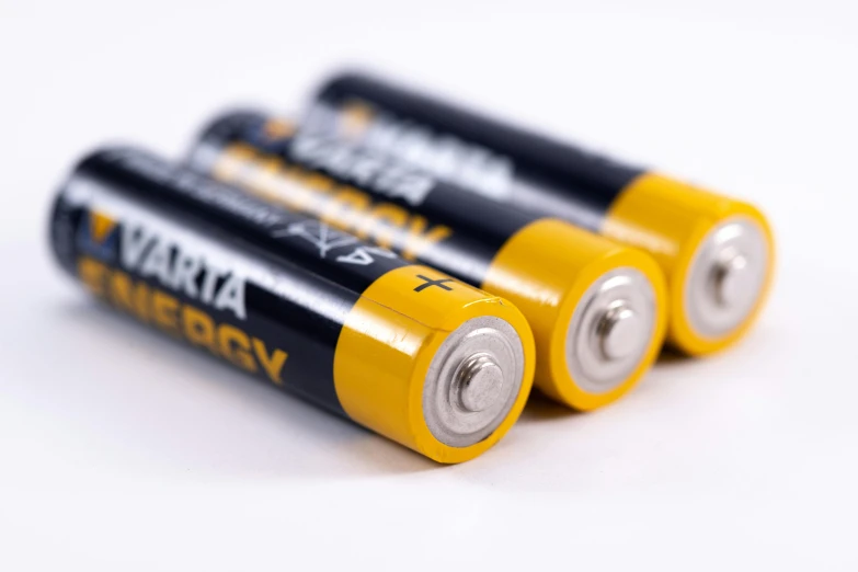 a couple of batteries sitting on top of each other, lined up horizontally, jerma985, with a white background, yellow charcoal