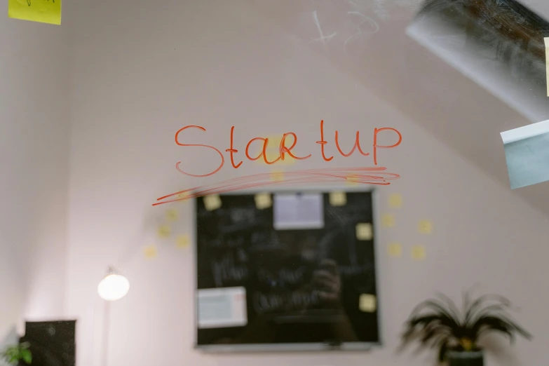 a blackboard with the word start up written on it, by Daniel Lieske, trending on unsplash, set inside of office, small starship near, shot from below, whiteboard