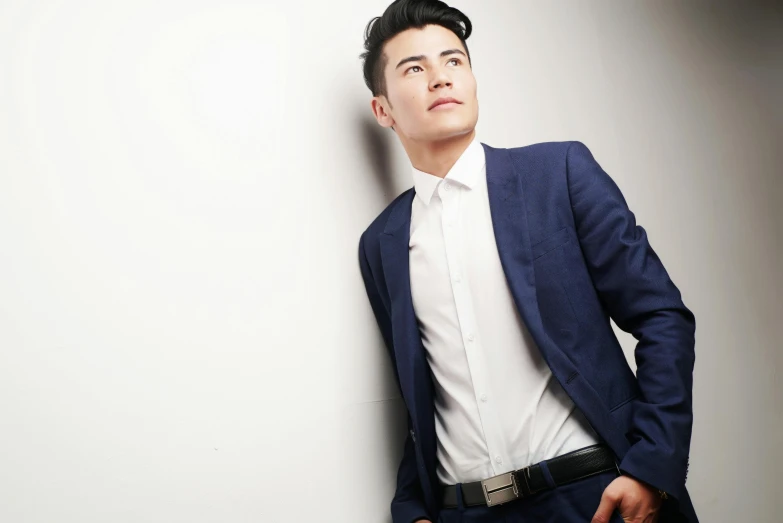a man in a suit leaning against a wall, an album cover, inspired by Huang Gongwang, pexels, attractive young man, waist up portrait, full colour, pan ren wei