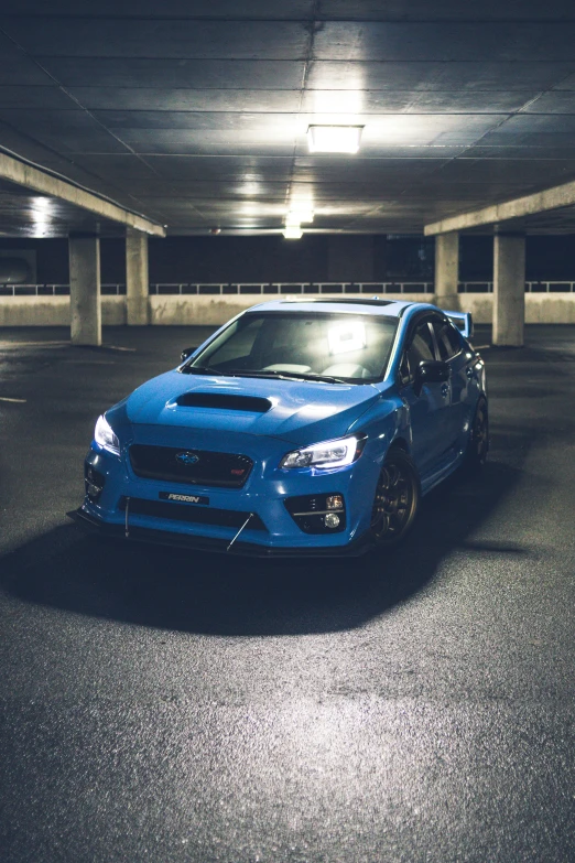 a blue subarunt parked in a parking garage, inspired by An Gyeon, pexels contest winner, wrx golf, nighttime!, instagram photo, menacing look