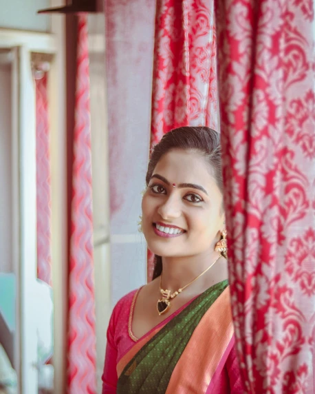 a woman standing in front of a red curtain, pexels contest winner, samikshavad, smiling and looking directly, near a window, square, profile image