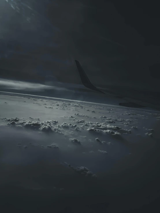 a large jetliner flying through a cloudy sky, an album cover, inspired by Michal Karcz, pexels contest winner, ☁🌪🌙👩🏾, cinematic detail, moody aesthetic, on the ground