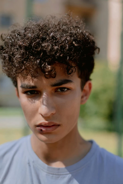 a close up of a person with a skateboard, by Daniel Seghers, trending on pexels, photorealism, curly pixie hair, brown skin man egyptian prince, nonbinary model, tommy 1 6 years old