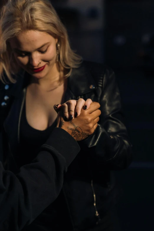 a man and a woman standing next to each other, a tattoo, inspired by Elsa Bleda, trending on pexels, photorealism, leather gloves, man proposing his girlfriend, mid night, blonde women