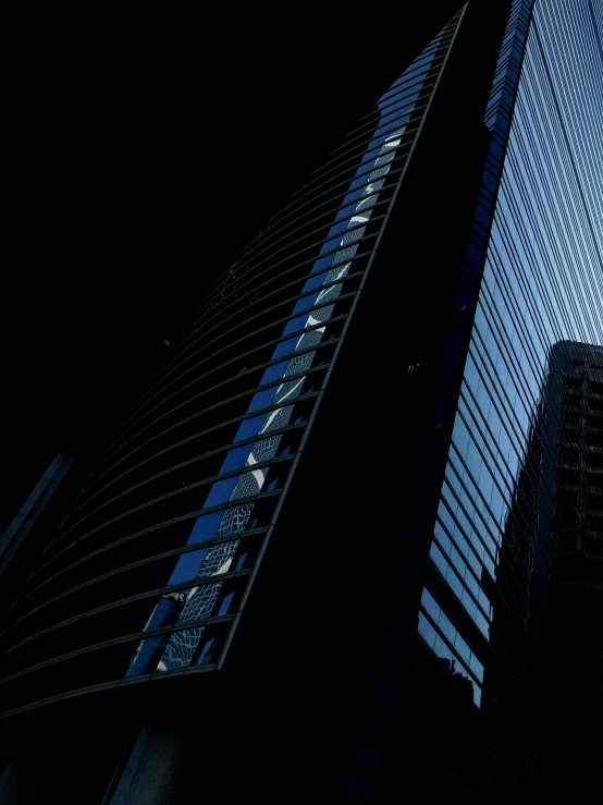 a couple of tall buildings sitting next to each other, by David Donaldson, blue light, dark and intricate photograph, ((monolith))