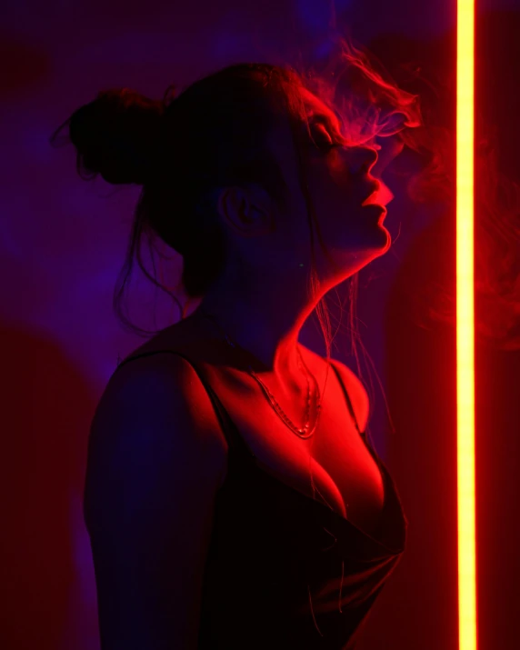 a woman standing in front of a neon light, inspired by Nan Goldin, pexels contest winner, smoking a magical bong, profile image, muted rainbow tubing, black and red colors