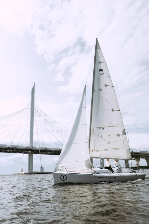 a sailboat in the water with a bridge in the background, skybridges, grey, upon a peak in darien, spire