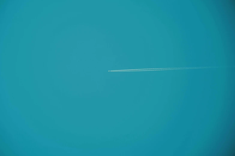 an airplane is flying in the blue sky, an album cover, by Jean-Yves Couliou, unsplash, minimalism, tiny spaceship!!, turqouise, meteor, minimalissimo