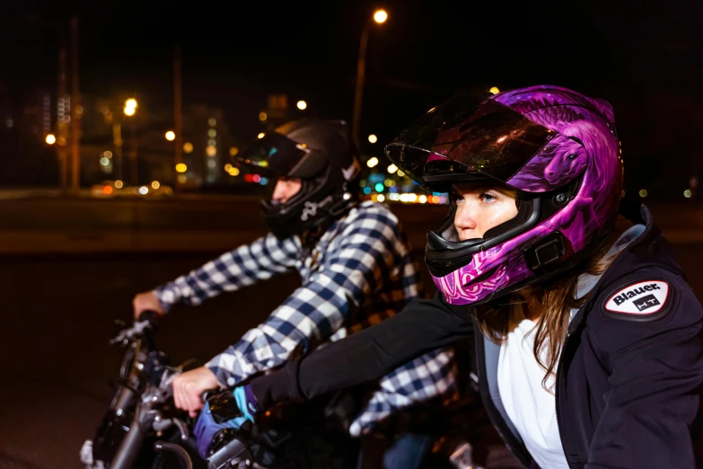 a couple of people riding on the back of a motorcycle, purple glow, wearing her helmet, 9 9 designs, close up photo