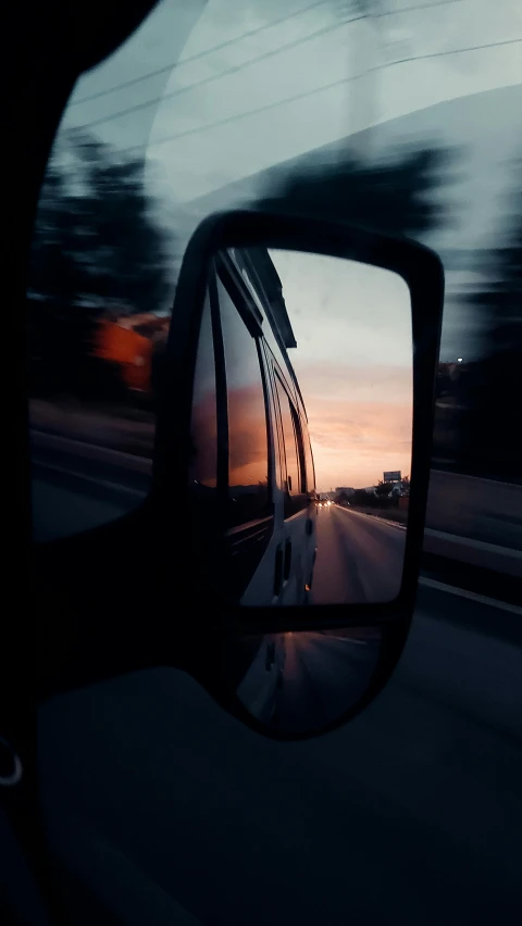 a rear view mirror on the side of a car, an album cover, by Brad Holland, pexels contest winner, magic hour, driving fast, view from a news truck, mirrors