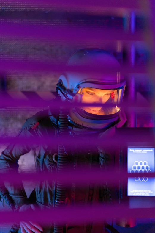a close up of a person in a space suit, a hologram, pexels contest winner, behind bars, purple scene lighting, industrial sci fi, riot shields