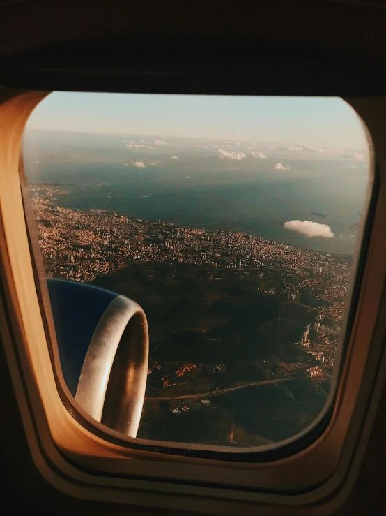 a view of a city from an airplane window, a picture, by Lucia Peka, happening, instagram post 4k, 🚿🗝📝, 90s photo