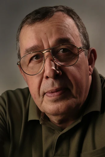 a man wearing glasses and a green shirt, photorealism, taken in the late 2010s, francois schuiten, professional closeup photo, high-resolution photo